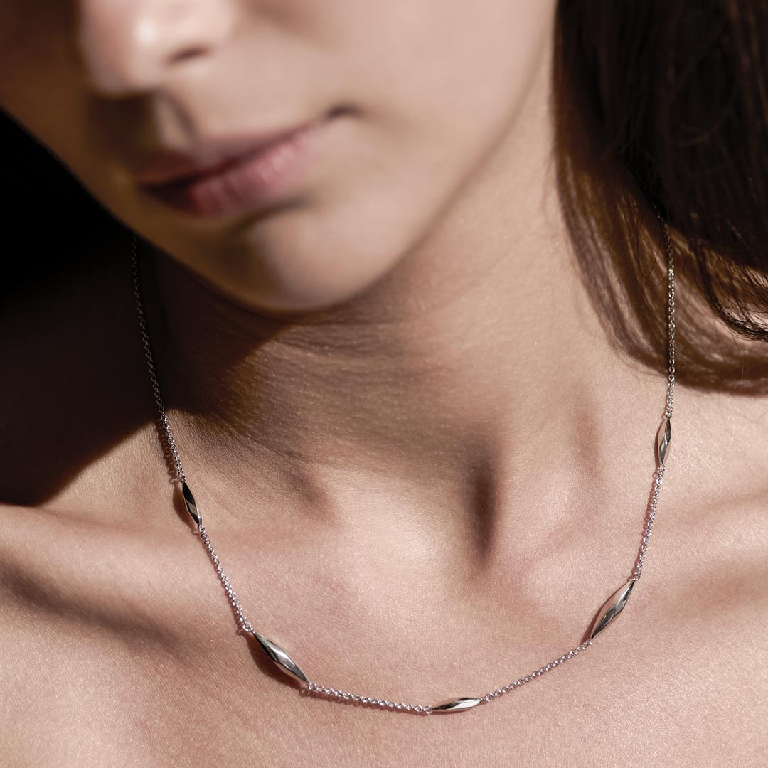 Model_wears_Glint_Station_Necklace_1.jpg